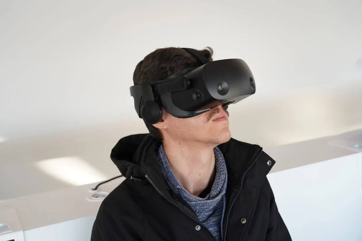 A person wearing a virtual reality headset, looking up